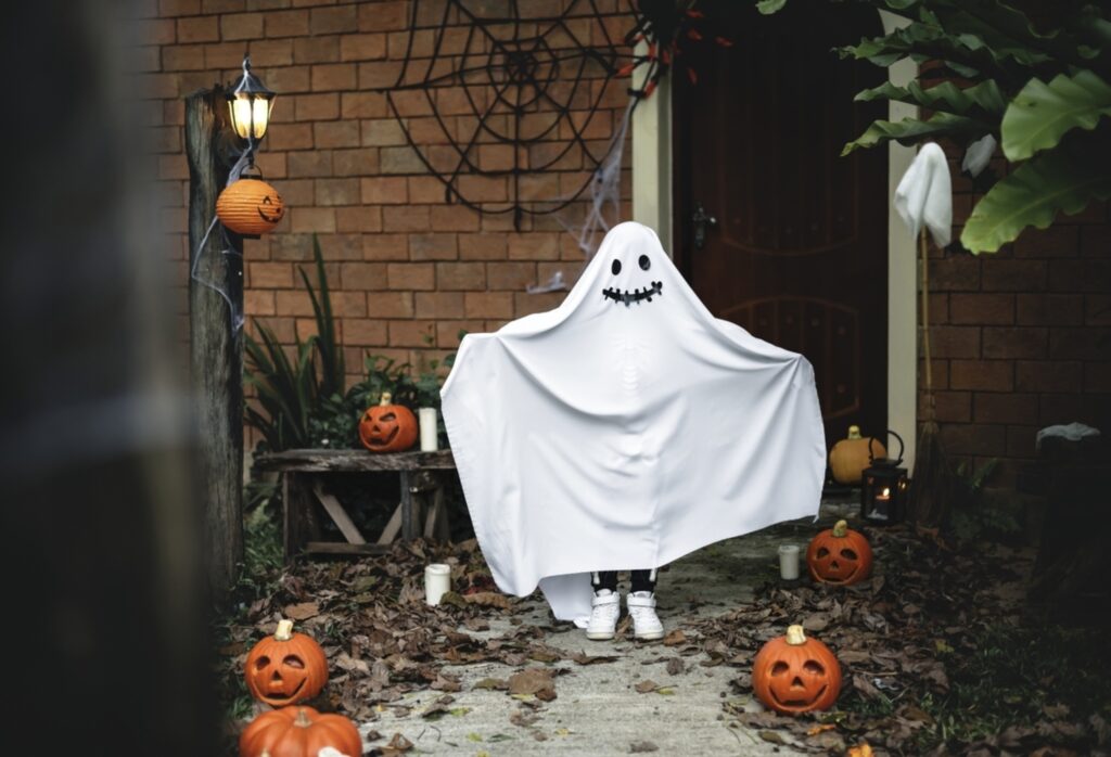 child in ghost costume made from white sheet 