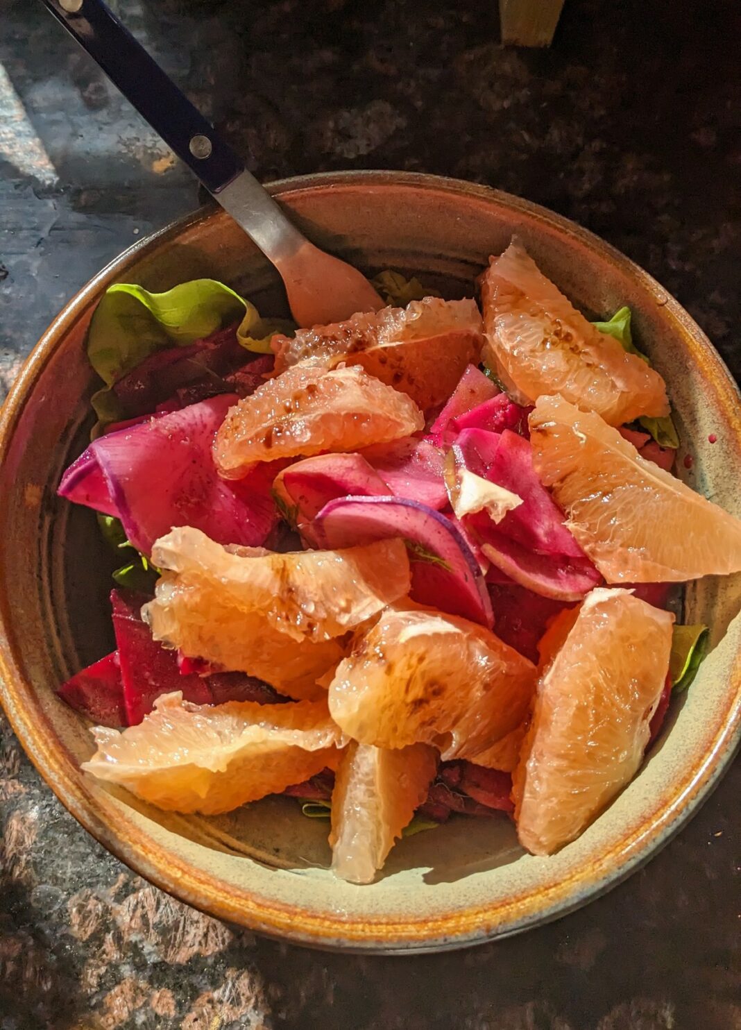 bowl of marinated raw root vegetables and fresh grapefruit